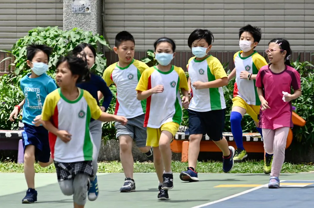Students run during a sports class at Dajia Elementary School in Taipei on April 29, 2020. (Sam Yeh/AFP via Getty Images)