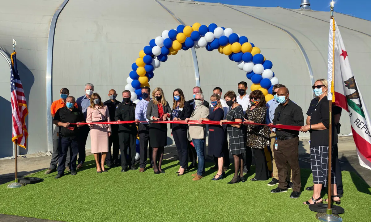 Officials gather for a ribbon-cutting ceremony in front of a new homeless shelter in Huntington Beach, Calif., on Nov. 2, 2020. (Drew Van Voorhis/The Epoch Times)