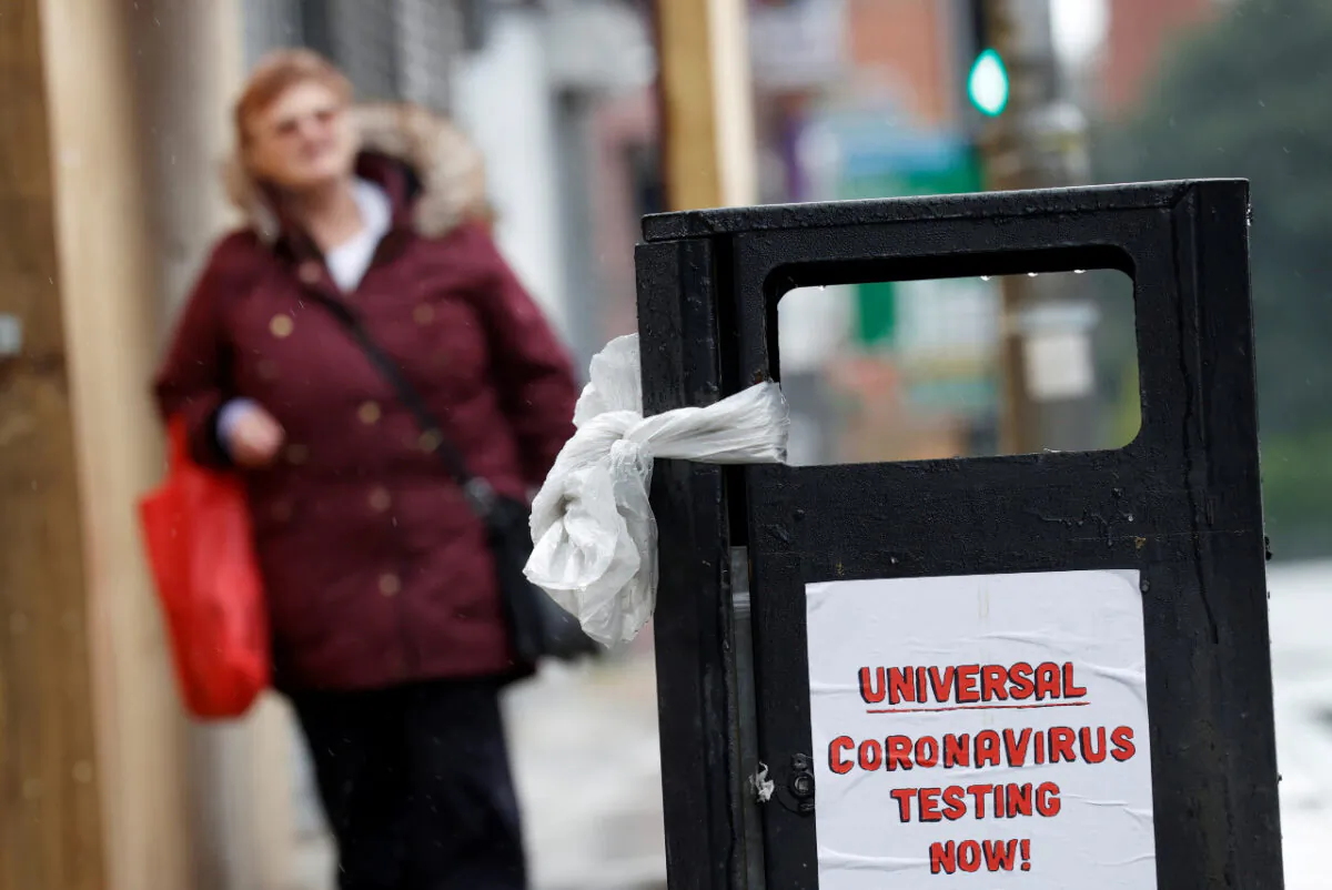 A poster reading "Universal Coronavirus Testing Now!" is seen on a bin in Liverpool, England, on April 18, 2020. (Reuters/Phil Noble)