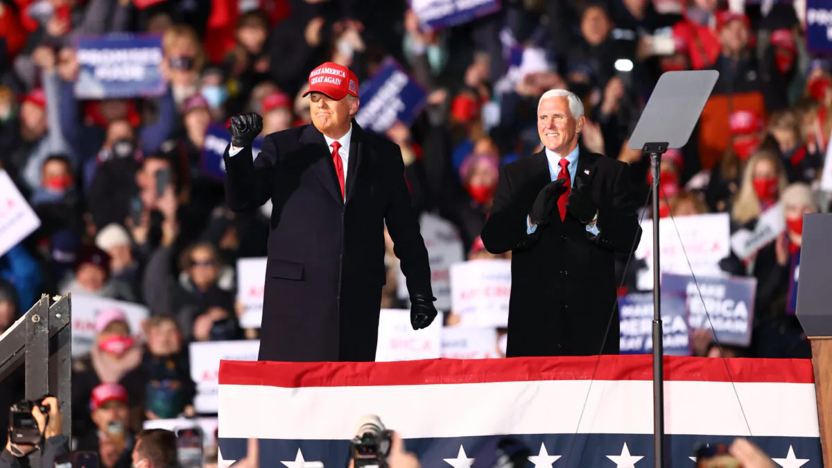 U.S. President Donald Trump (L) and U.S. Vice President Mike Pence (R) greet supporters at a rally in Traverse City, Mich., on Nov. 2, 2020. (Rey Del Rio/Getty Images)