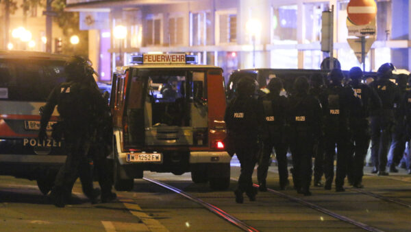 Police officers walk at the scene