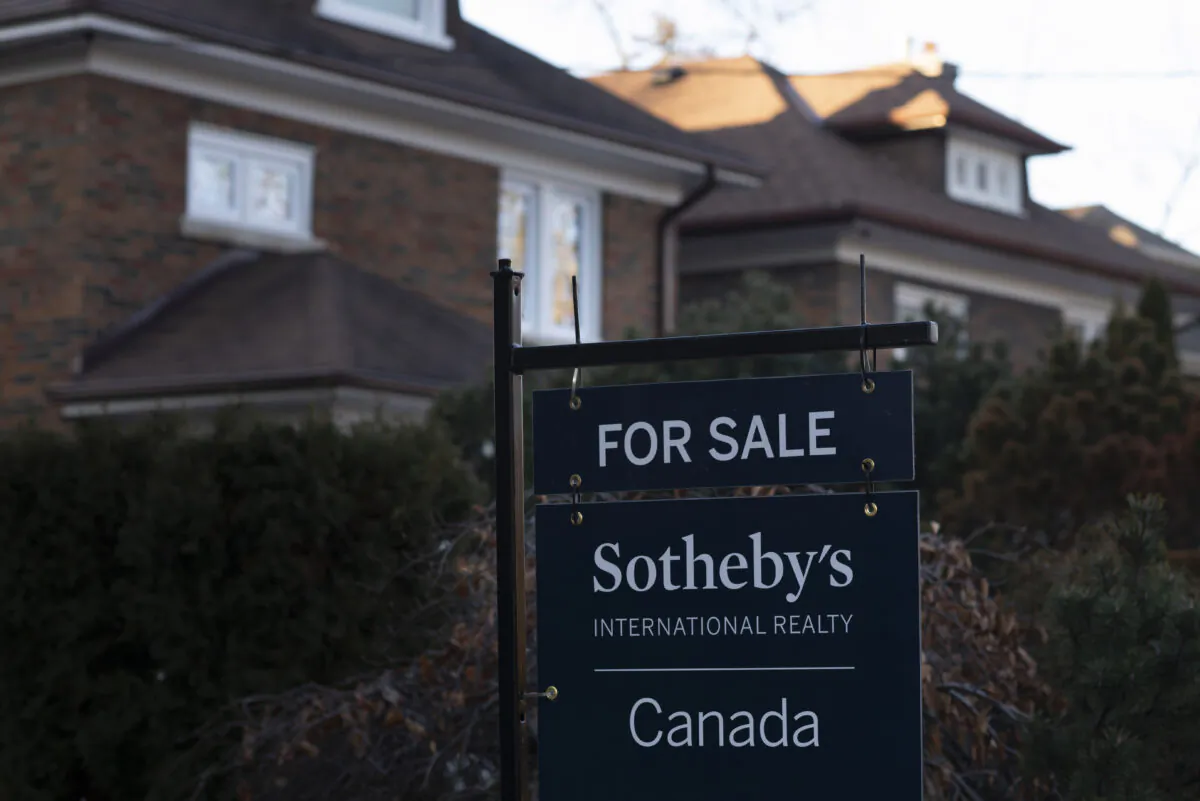 A real estate sale sign is shown in a west-end Toronto neighbourhood on March 7, 2020. (Graeme Roy/The Canadian Press)