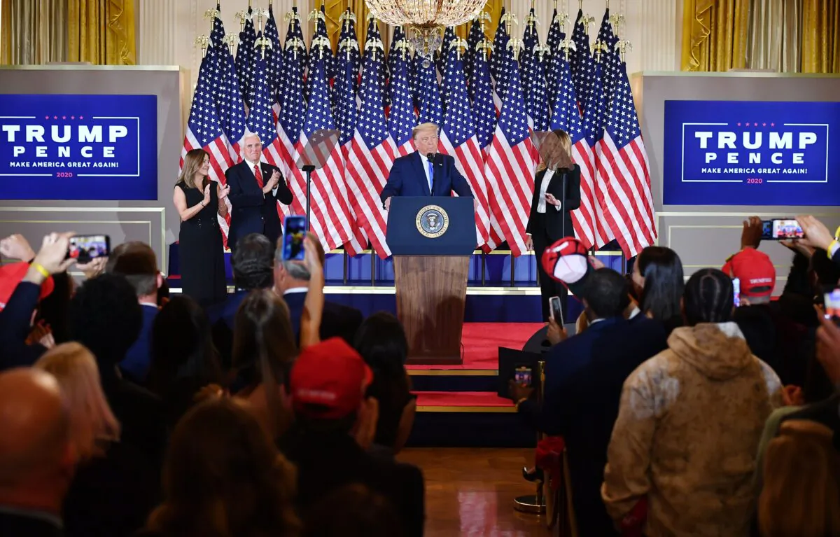 President Donald Trump, flanked by Karen Pence (L), Vice President Mike Pence, and First Lady Melania Trump, speaks during election night in the East Room of the White House early on Nov. 4, 2020. (Mandel Ngan/AFP via Getty Images)