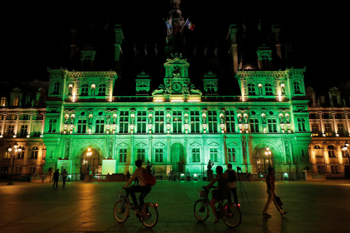 Green lights are projected onto the facade of the Hotel de Ville in Paris after President Donald Trump announced his decision that the US will withdraw from the Paris Climate Agreement at a news conference on June 1, 2017. (Philippe Wojazer/Reuters)