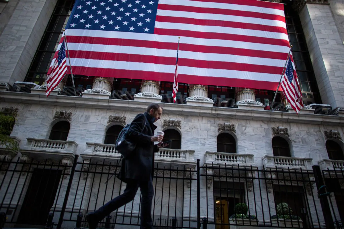A man walks by the New York Stock Exchange (NYSE) in New York, on Nov. 4, 2020. (KENA BETANCUR/AFP via Getty Images)