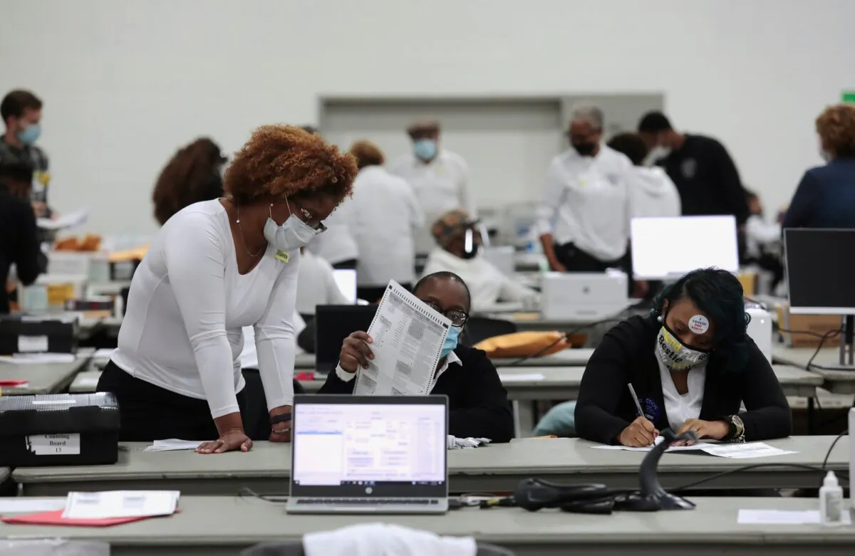 Poll workers tabulate absentee ballots at the TCF Center during Election Day in Detroit, Mich., Nov. 3, 2020. (Rebecca Cook/Reuters)