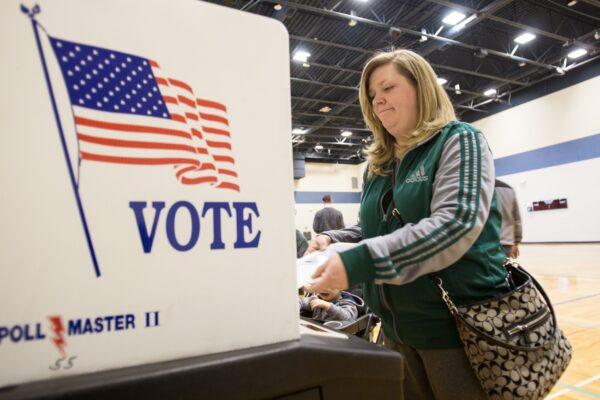 A voter casts her ballot