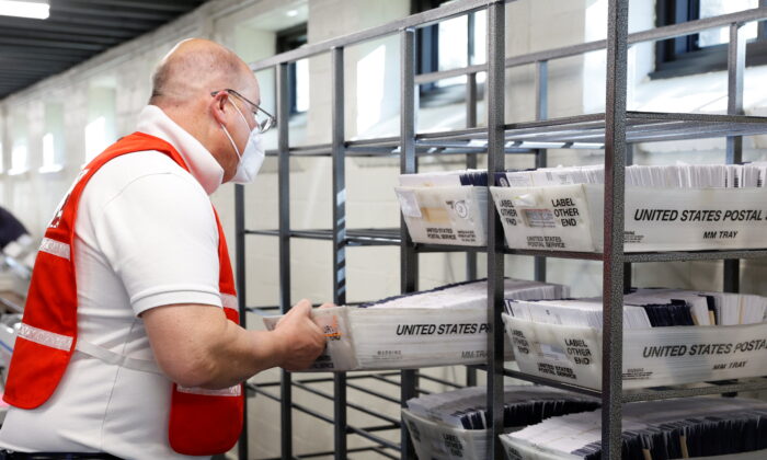 An election worker is seen as mail-in ballots are counted in Chester County, Pa., on Nov. 4, 2020. (Rachel Wisniewski/Reuters)