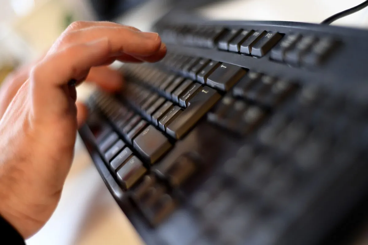 An person typing on a computer keyboard in Moscow on Oct. 17, 2016. (Kirill Kudryavtsev/AFP via Getty Images)