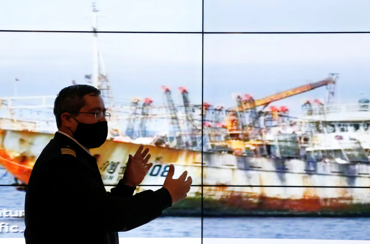 Chile's Commander Rodrigo Lepe, Chief of the fishing department of the maritime territory, shows a ship as a part of a large fleet of Chinese fishing vessels, who Chilean government is keeping tabs, while fishing along the Pacific Coast of South America, in Valparaiso, Chile Oct. 8, 2020. (REUTERS/Rodrigo Garrido)