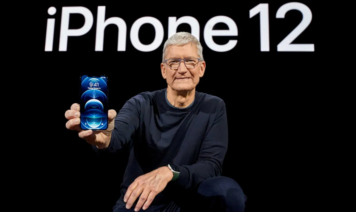 Apple CEO Tim Cook poses with the all-new iPhone 12 Pro at Apple Park in Cupertino, Calif., on Oct. 13, 2020. (Brooks Kraft/Apple Inc./Handout via Reuters)