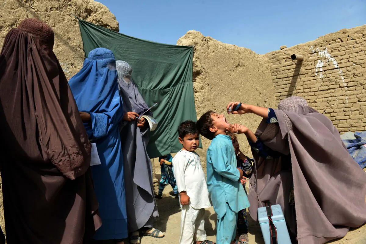 An Afghan health worker administers polio vaccine to a child in Arghandab district of Kandahar Province on Aug. 17, 2018. (Javed Tanveer/AFP via Getty Images)