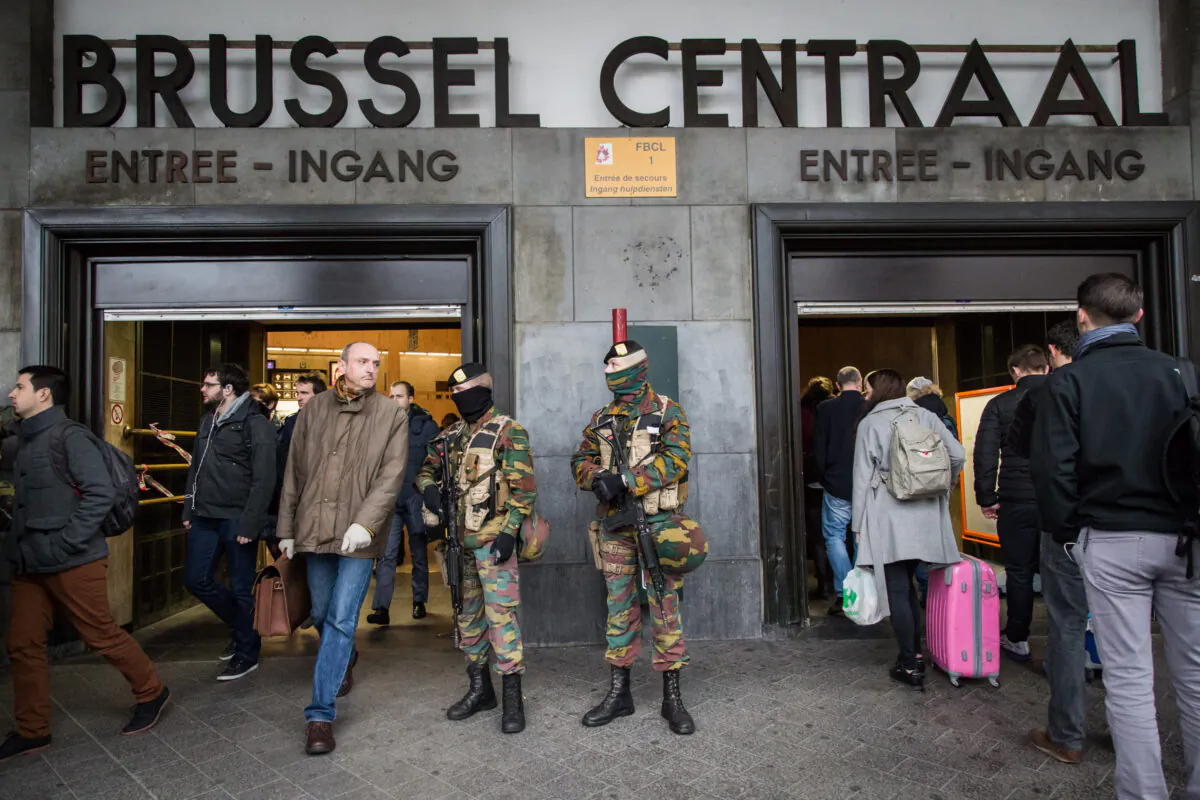 One day after the attacks on a Brussels airport and at a metro station, soldiers stand guard at the entrance of Brussels' central station on Mar. 23, 2016. (Aurore Belot/AFP via Getty Images)