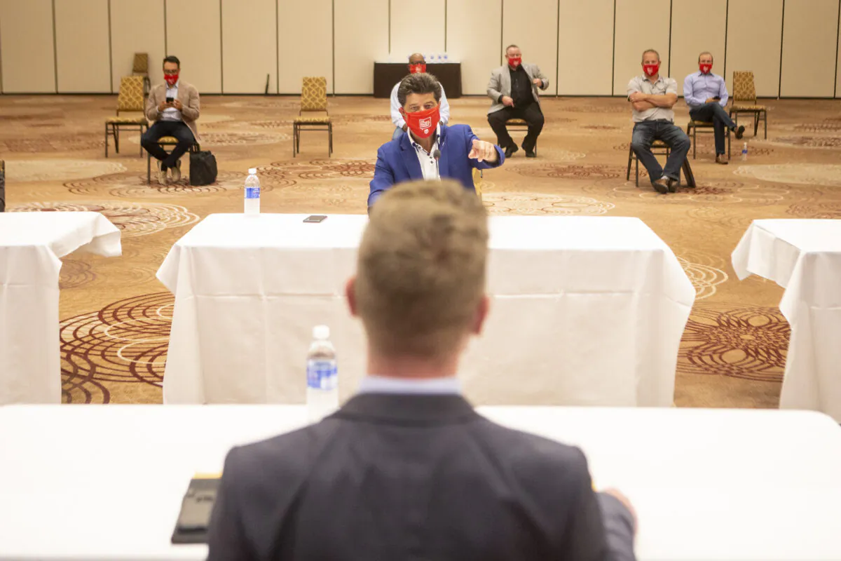 Jerry Dias, President of the Unifor union, sits opposite Matt Hough, General Motors' general director of human resources  and labour relations, at the start of formal contract talks with the Detroit Three automakers, Fiat Chrysler, Ford and General Motors, in Toronto, on Aug. 12, 2020. (The Canadian Press/Chris Young)