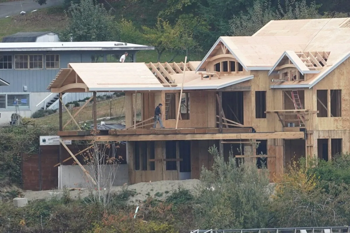Workers are shown on a home under construction,  along the waterfront in Gig Harbor, Wash., on Oct. 28, 2020. (Ted S. Warren/AP Photo)