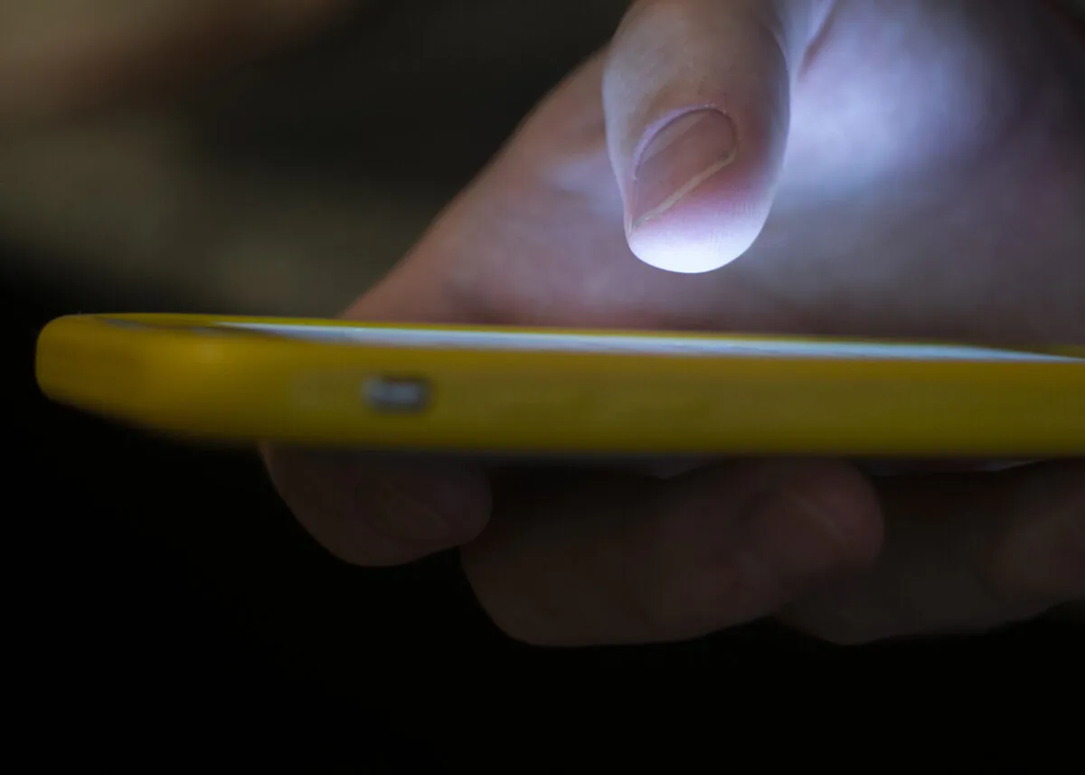 A man uses a cell phone in New Orleans, La., on Aug. 11, 2019. (Jenny Kane/The Associated Press)
