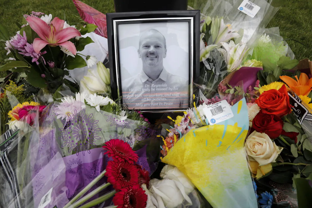 An impromptu memorial for Dr. Walter Reynolds, who died after he was attacked in an examination room rests outside the Village Mall walk-in clinic in Red Deer, Alta., on Aug. 11, 2020.  (The Canadian Press/Jeff McIntosh)