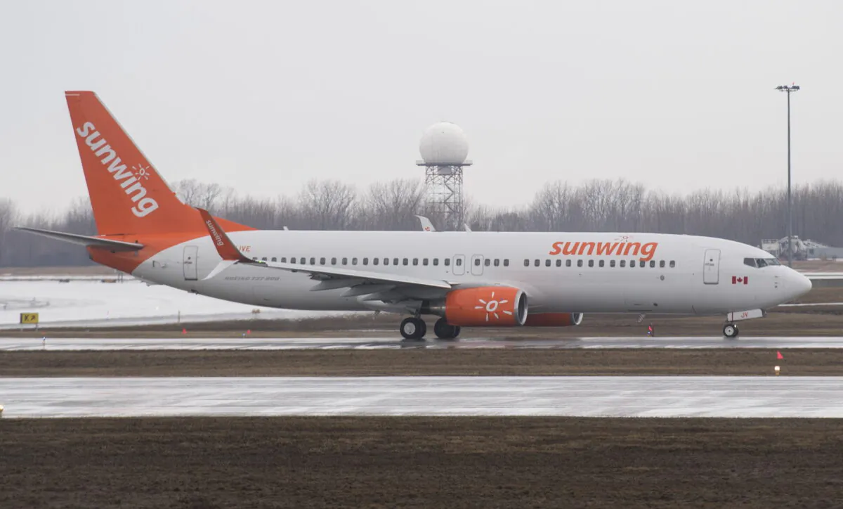 A Sunwing Airlines jet prepares to take off at Montreal's Trudeau International Airport on March 20, 2020, as COVID-19 cases rise in Canada and around the world. (The Canadian Press/Graham Hughes)
