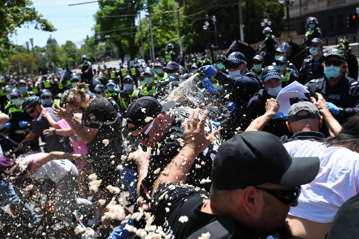 Police use OC spray on protesters during an anti-lockdown protest in Melbourne, Australia, on Nov. 3, 2020. (AAP Image/Erik Anderson)