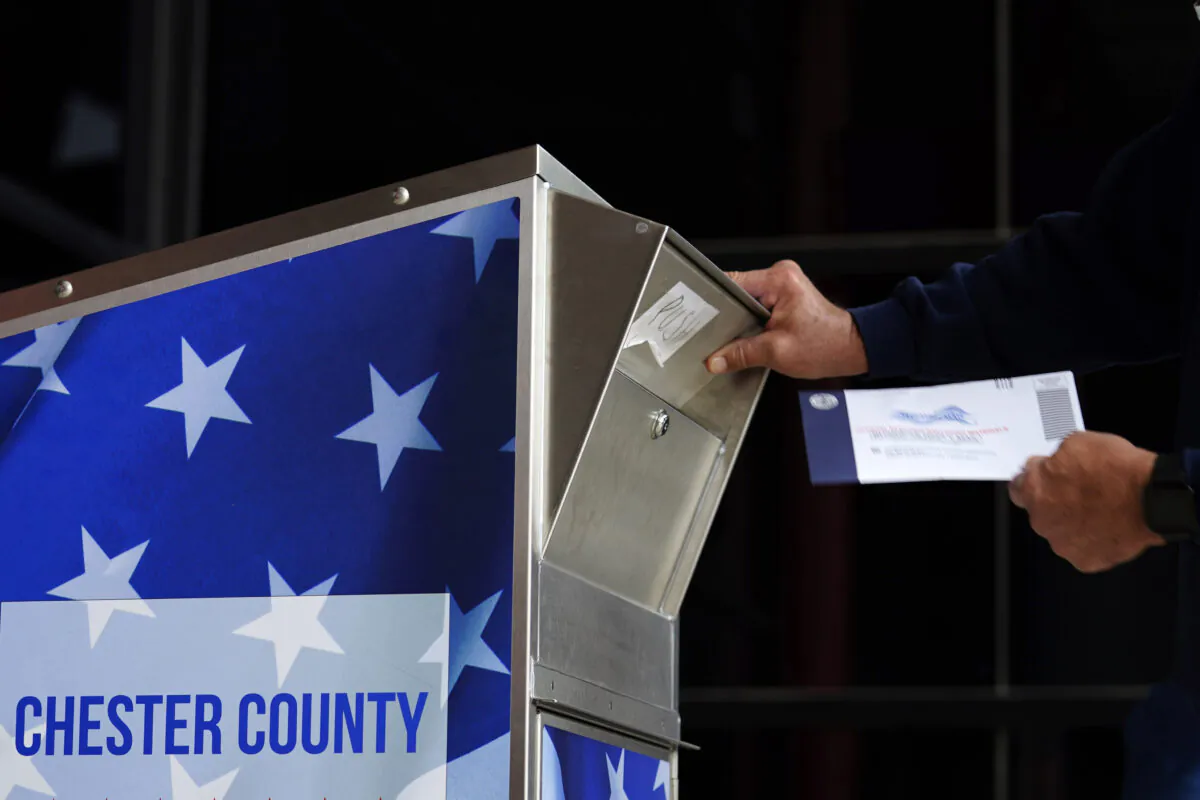 A man drops off his ballot for the 2020 General Election in the United States outside the Chester County Government Services Center in West Chester, Pa., on Oct. 23, 2020. (Matt Slocum/AP Photo)