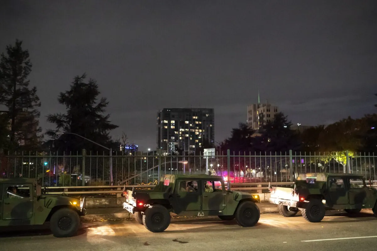 An Oregon State National Guardsman watches the crowd while dispersing protesters early in the morning in Portland, Ore., on Nov. 5, 2020. (Nathan Howard/Getty Images)