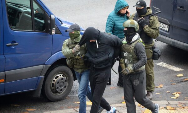 Police detain a man
