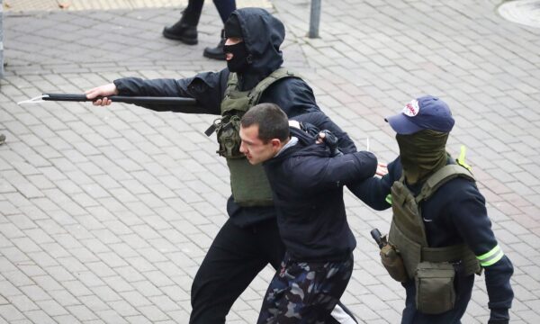 Police detain a man