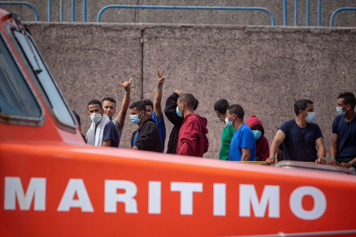 Migrants from a group of 1300 rescued from different boats remain in the port of Arguineguin while being cared for by the Spanish Red Cross and the National Police on the Spanish Canary island of Gran Canaria, on Oct. 25, 2020. (Desiree Martin/AFP via Getty Images)