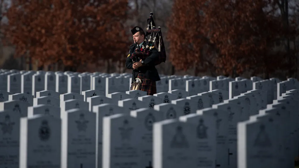 A piper prepares for an internment ceremony at the National Military Cemetery in Ottawa on Nov. 7, 2020. (The Canadian Press/ Justin Tang)