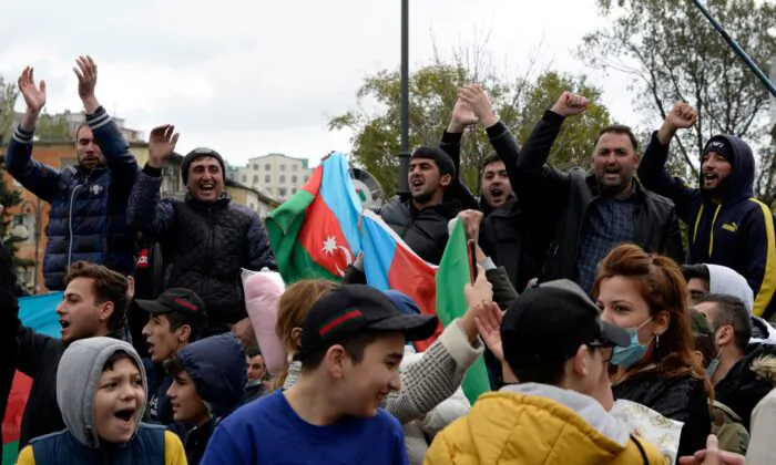People celebrate on the streets after Azerbaijan's President Ilham Aliyev said the country's forces had taken Shusha, which Armenians call Shushi, during the fighting over the breakaway region of Nagorno-Karabakh, in Baku, Azerbaijan, on Nov. 8, 2020. (Stringer/Reuters)