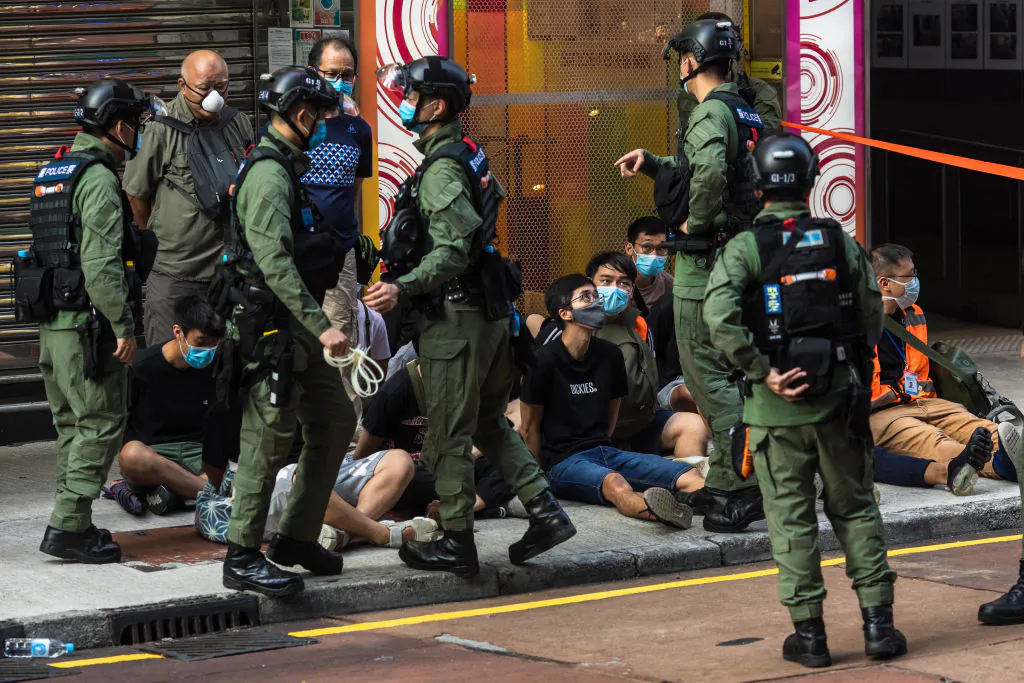 Police detain people as they patrol the area after protesters called for a rally in Hong Kong on Sept. 6, 2020. (Dale De Lay Rey/AFP via Getty Images)