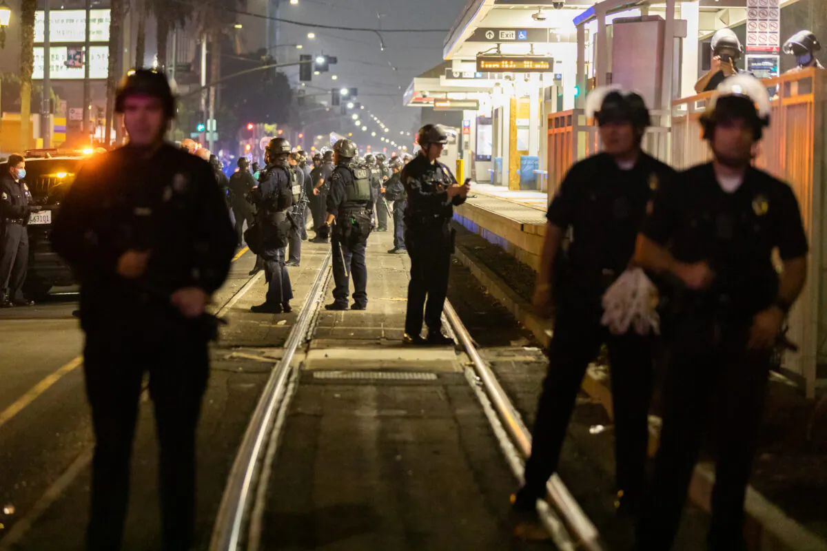 Police stand at the Blue Line station in downtown Los Angeles, where protesters blocked the track on Nov. 3, 2020. (John Fredricks/The Epoch Times)