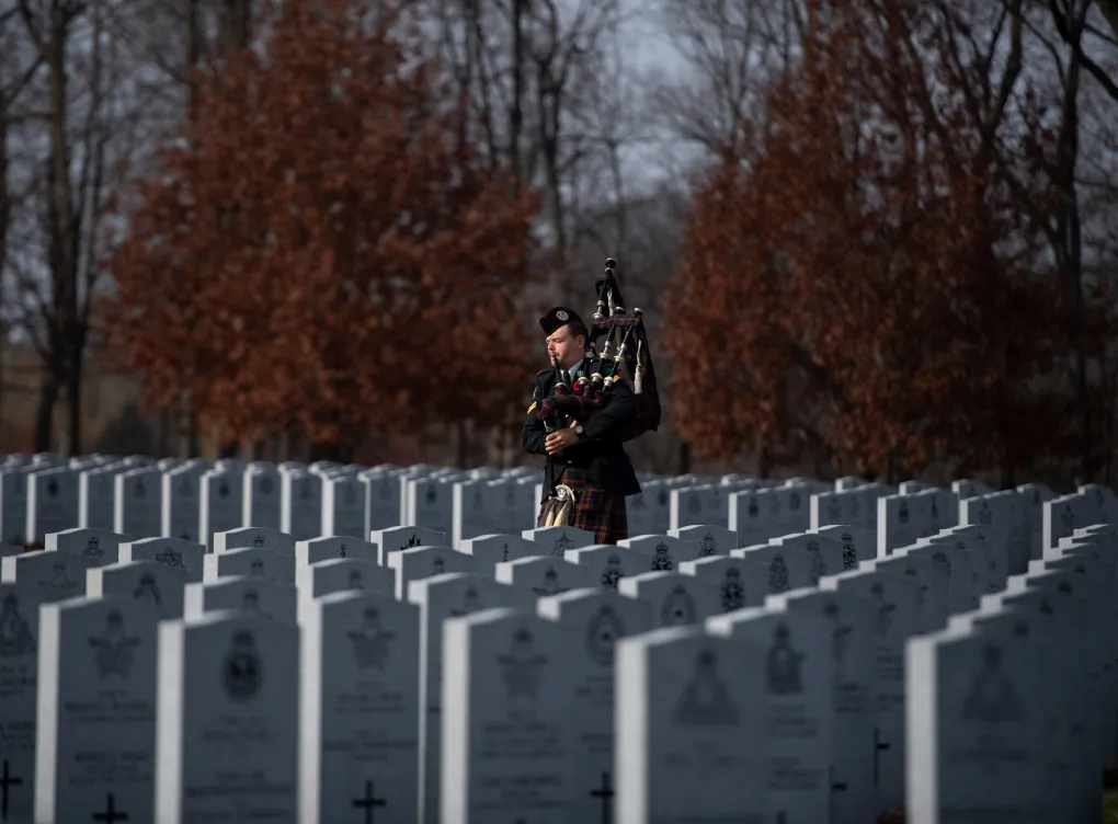 A piper prepares for an internment ceremony at the National Military Cemetery in Ottawa on Nov. 7, 2020. (The Canadian Press/Justin Tang)