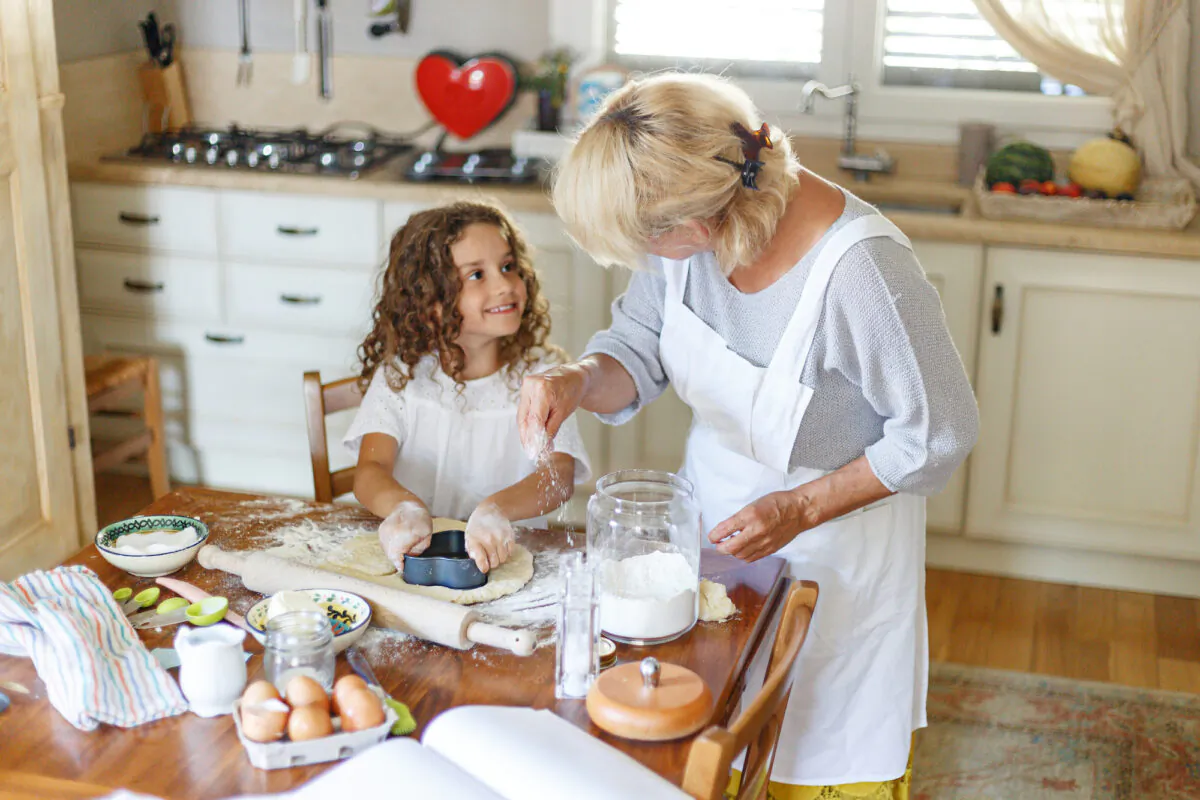 Kids can have a lot of fun in the kitchen, whether it's filling measuring cups, cracking eggs, or rinsing veggies.  (Dragosh Co/Shutterstock)