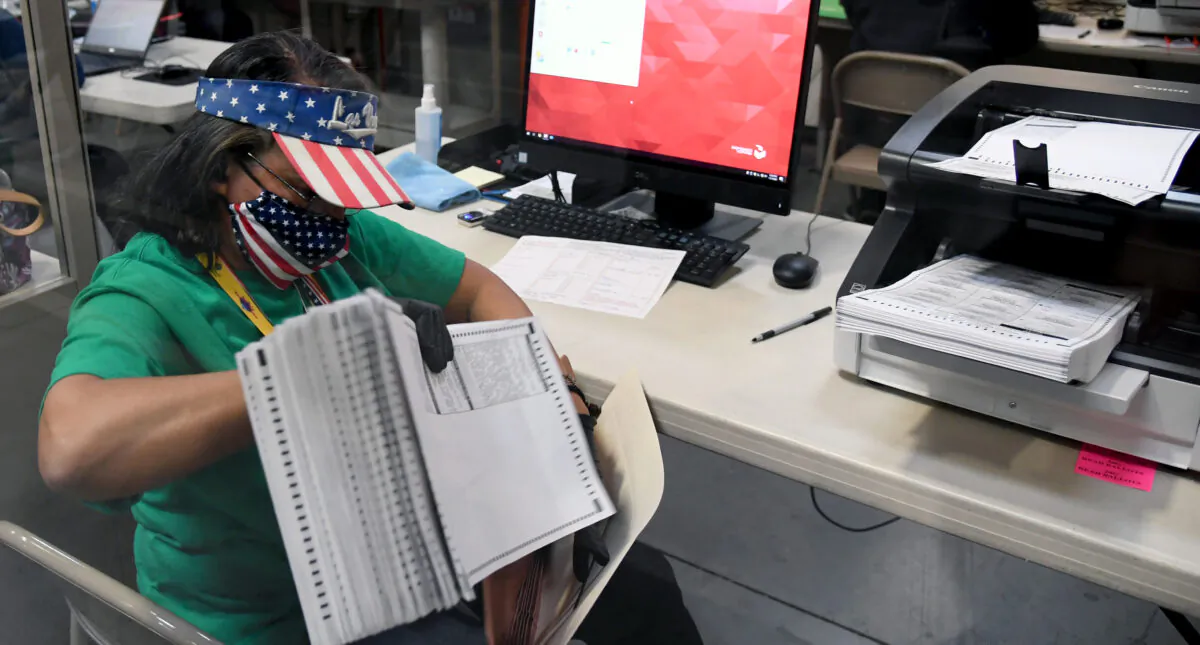 A Clark County election worker scans mail-in ballots at the Clark County Election Department in North Las Vegas, Nev., on Nov. 7, 2020. (Ethan Miller/Getty Images)