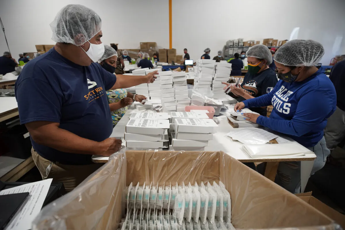 Employees at Spectrum Solutions prepare COVID-19 saliva test kits for shipment in Draper, Utah, on Sept. 21, 2020. (George Frey/Getty Images)