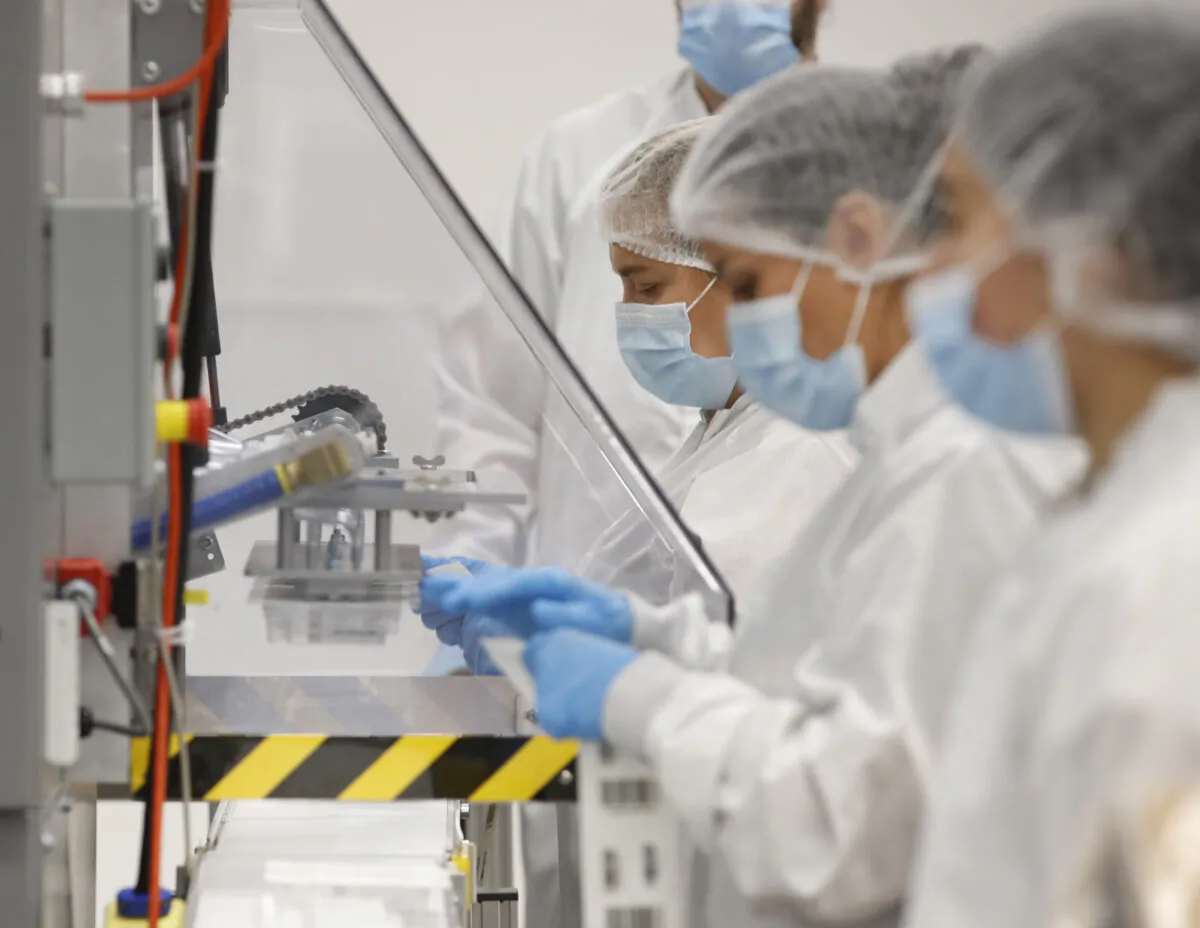 Employees at Spectrum Solutions prepare COVID-19 saliva test kits for shipment in Draper, Utah, on Sept. 21, 2020. (George Frey/Getty Images)