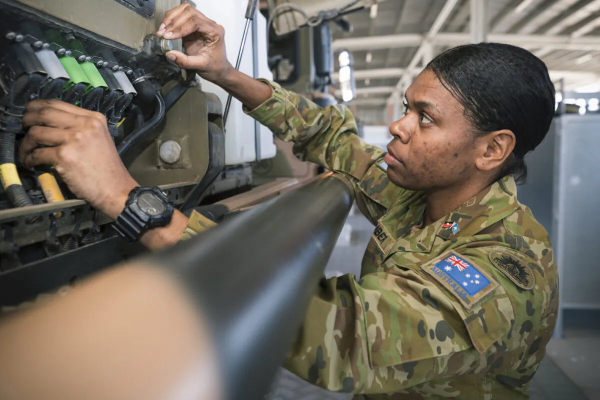 3rd Combat Service Support Battalion Driver Specialist Private Pamela Amber conducts an inspection on an Australian Army MAN HX77 vehicle at Lavarack Barracks, Townsville. (PTE Madhur Chitnis via ADF)