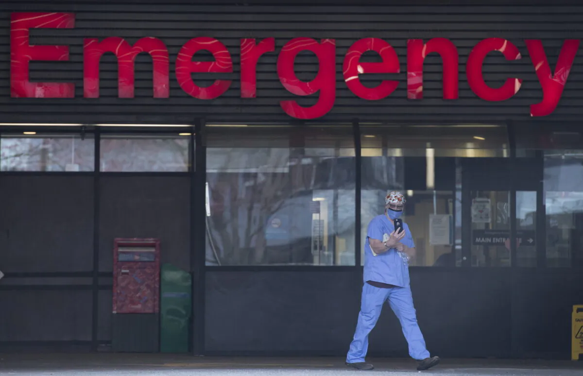 A health care worker is seen outside the Emergency Department of the Vancouver General Hospital in Vancouver on March 30, 2020. (The Canadian Press/Jonathan Hayward)