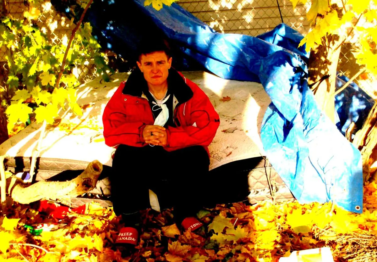 Sandra Lillie sits on the mattress on which she slept in a park in Ottawa, with the tarpaulin she used for cover to the side, after she got kicked out of her basement apartment on Oct. 30, 2020. (Courtesy of Colin Alexander)