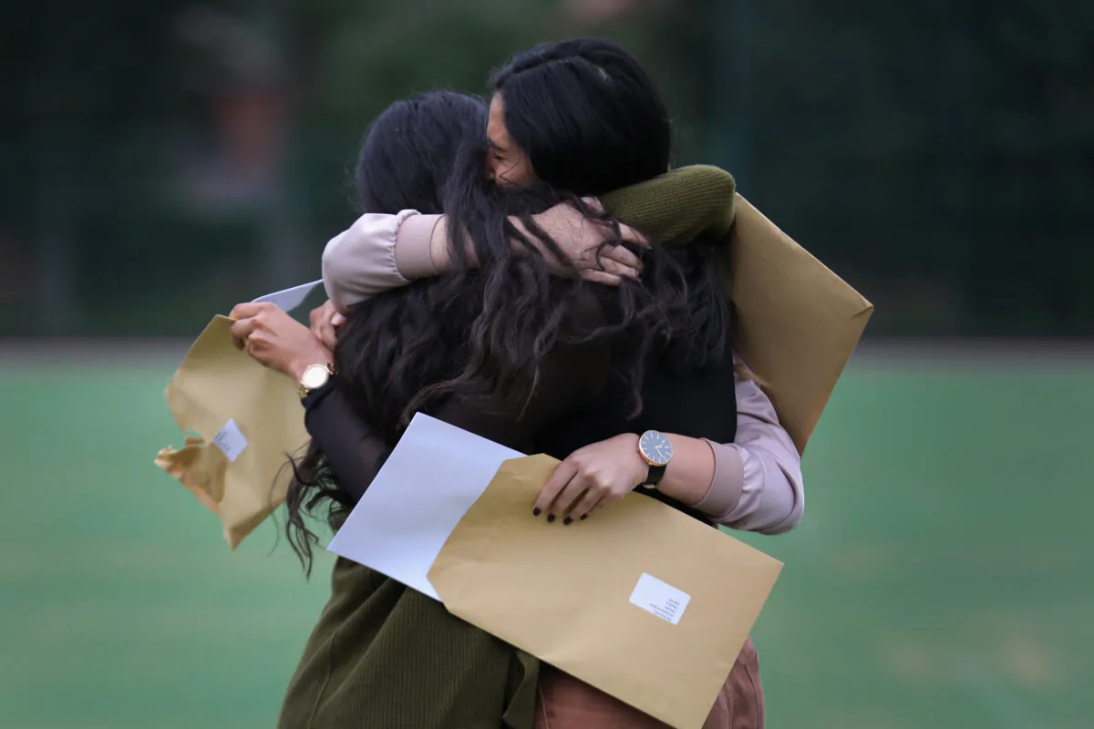Pupils at Withington Girls' School react as they open their GCSE exam results in Manchester, England on Aug. 25, 2016. (Christopher Furlong/Getty Images)