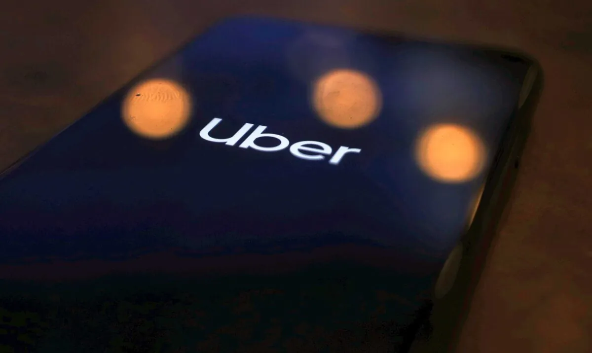 The Uber logo is displayed on a mobile phone in this picture illustration taken on Nov. 25, 2019. (Hannah McKay/Reuters)