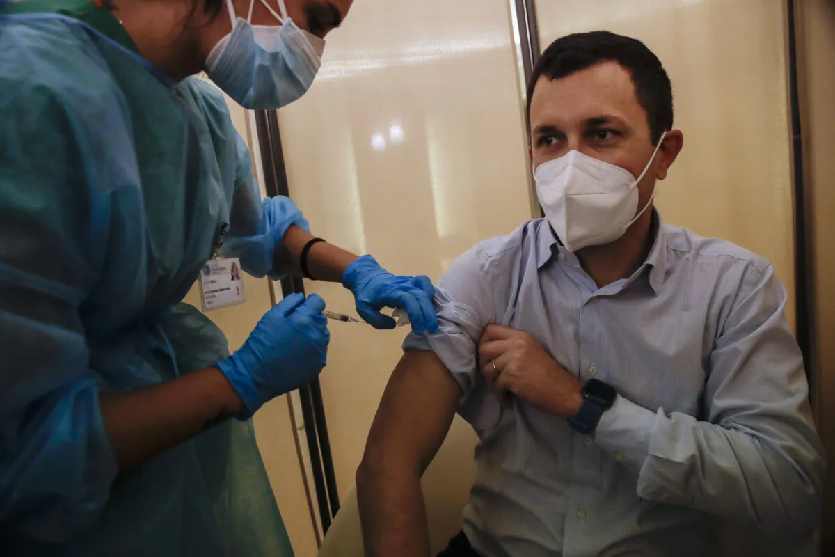 People receives flu vaccine at the Museum of science and technology in Milan, Italy on Nov. 4, 2020. (Luca Bruno/The Associated Press)