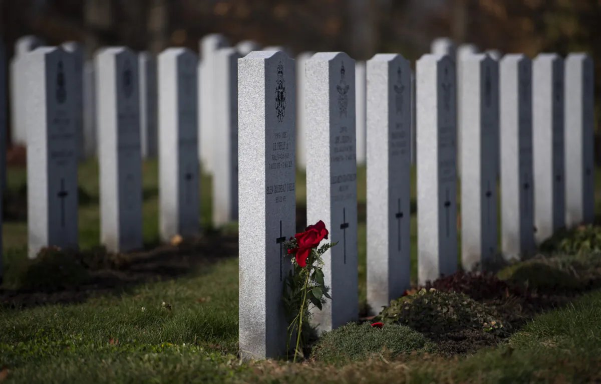 A rose lies against a tombstone at the National Military Cemetery in Ottawa on Nov. 7, 2020. (Justin Tang/The Canadian Press)