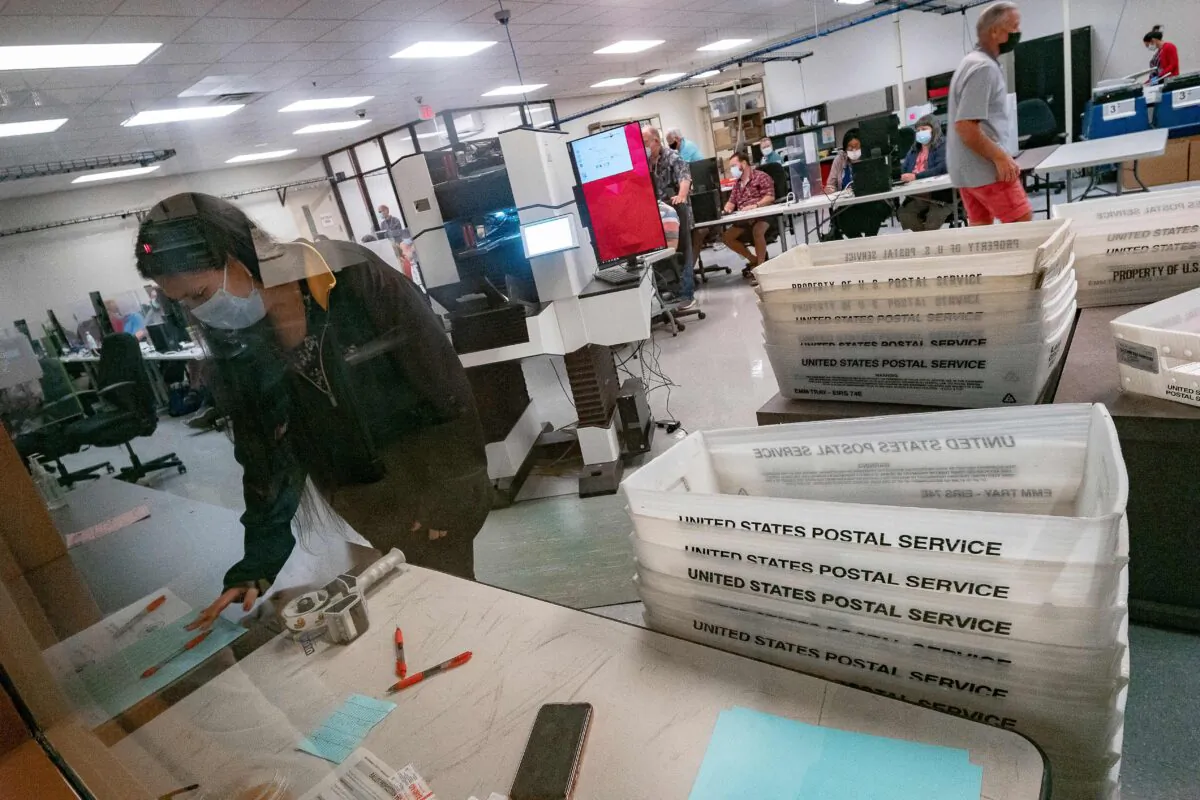 Poll workers count ballots inside the Maricopa County Election Department in Phoenix, Ariz. on Nov. 5, 2020 (Olivier Touron/AFP via Getty Images)