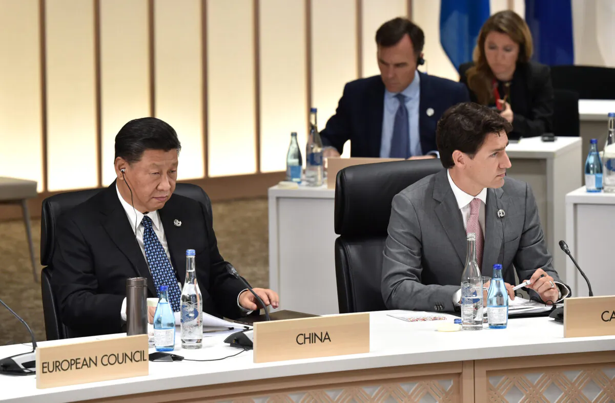 Chinese leader Xi Jinping (L) and Canada's Prime Minister Justin Trudeau attend a session at the G20 Summit in Osaka, Japan, on June 29, 2019. (Kazuhiro Nogi/Pool via Reuters)