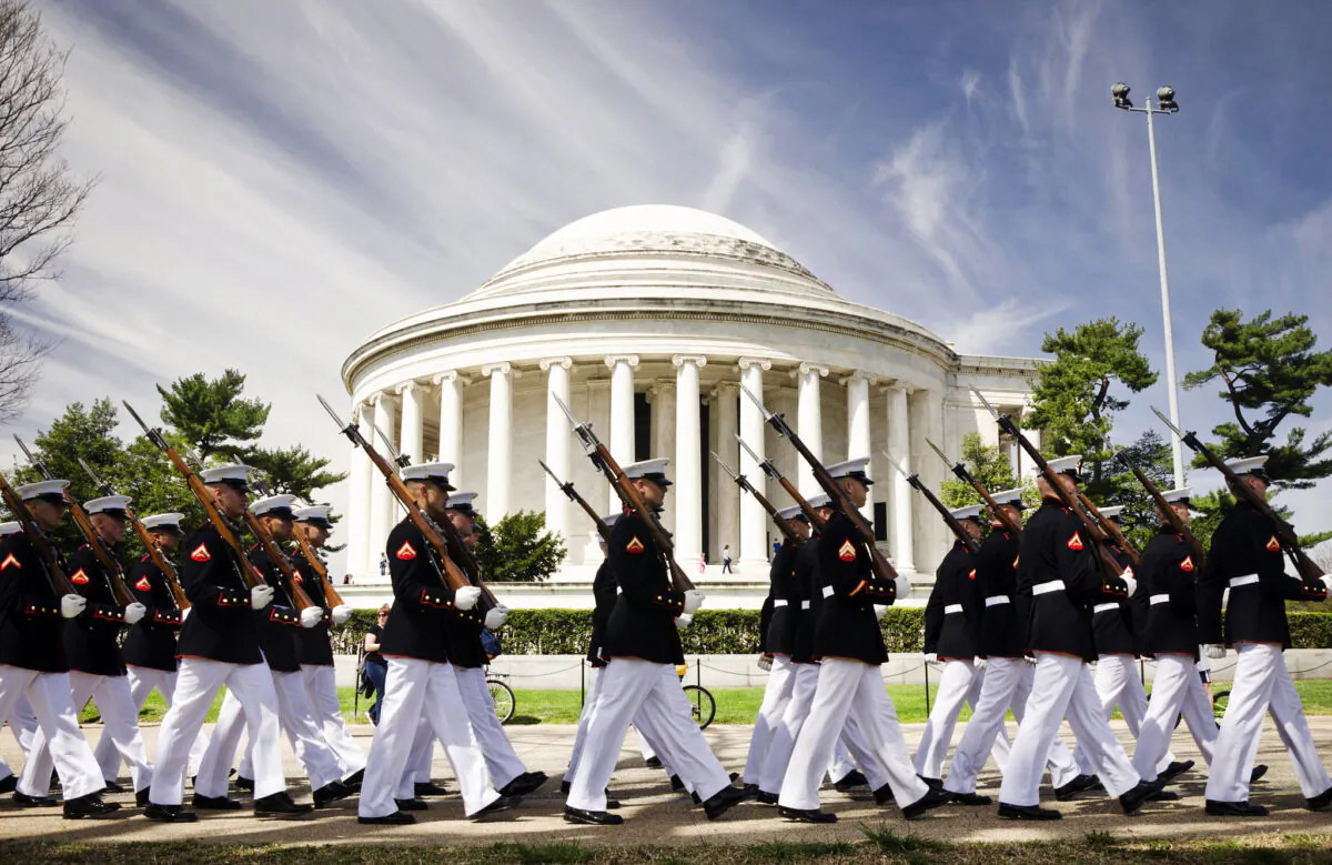 The Marine Corps Silent Drill Platoon marches in front of the Thomas Jefferson Memorial on its way to perform for the Cherry Blossom Festival in Washington April 12, 2014. (U.S. Marine Corps photo by Sgt. Bryan Nygaard/Released)
