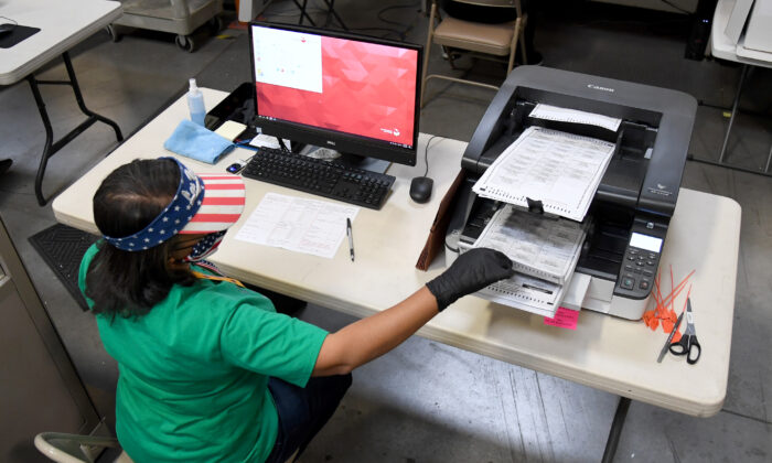 A Clark County election worker scans mail-in ballots at the Clark County Election Department in North Las Vegas, on Nov. 7, 2020. (Ethan Miller/Getty Images)