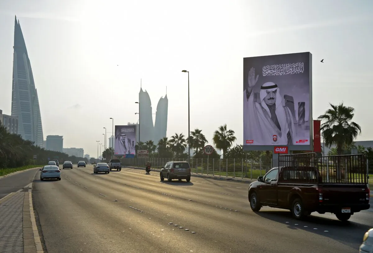 Cars drive on a highway past large posters of the late prince Khalifa bin Salman al-Khalifa, in the Bahraini capital Manama, Khalifa, on Nov. 11, 2020. (Mazen Mahdi/AFP via Getty Images)