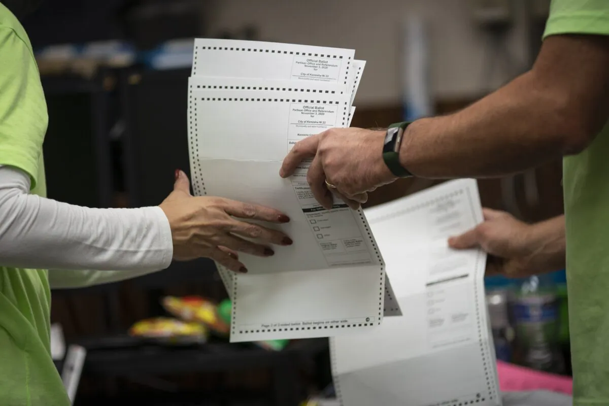 Poll workers sort out early and absentee ballots at the Kenosha Municipal building on Election Day in Kenosha, Wis., on Nov. 3, 2020. (Wong Maye-E/AP Photo)